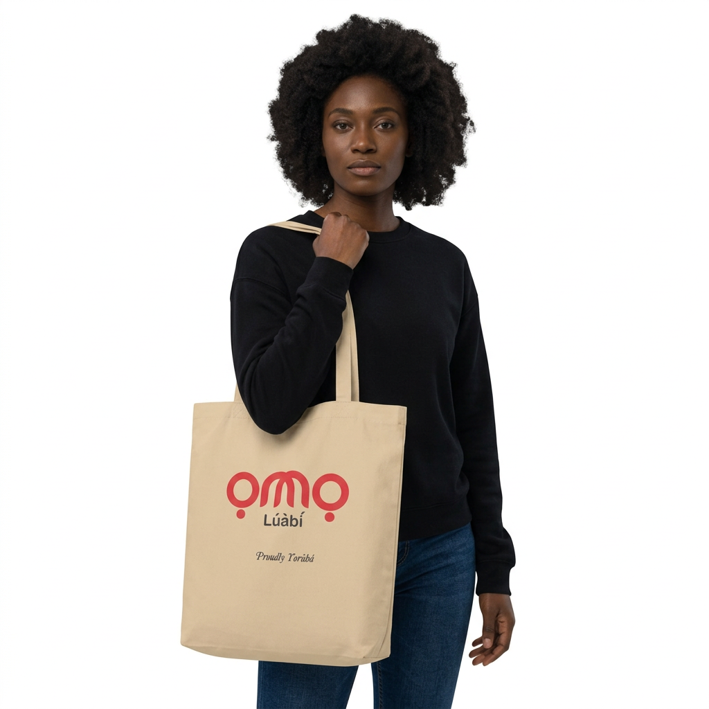 Black female model carrying the OMO LÚÀBÌ tote bag