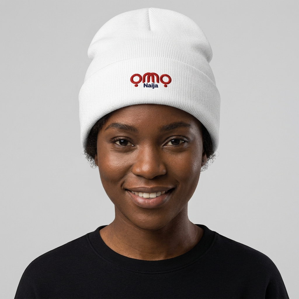 Black female model wearing the white ỌMỌ Naija beanie