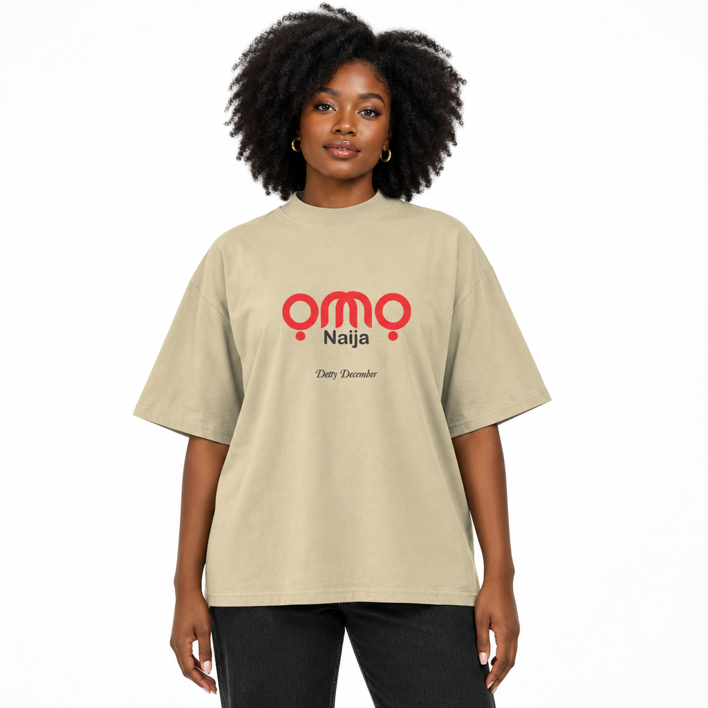 Black female model wearing the stone oversized OMO Naija Detty December T-shirt.